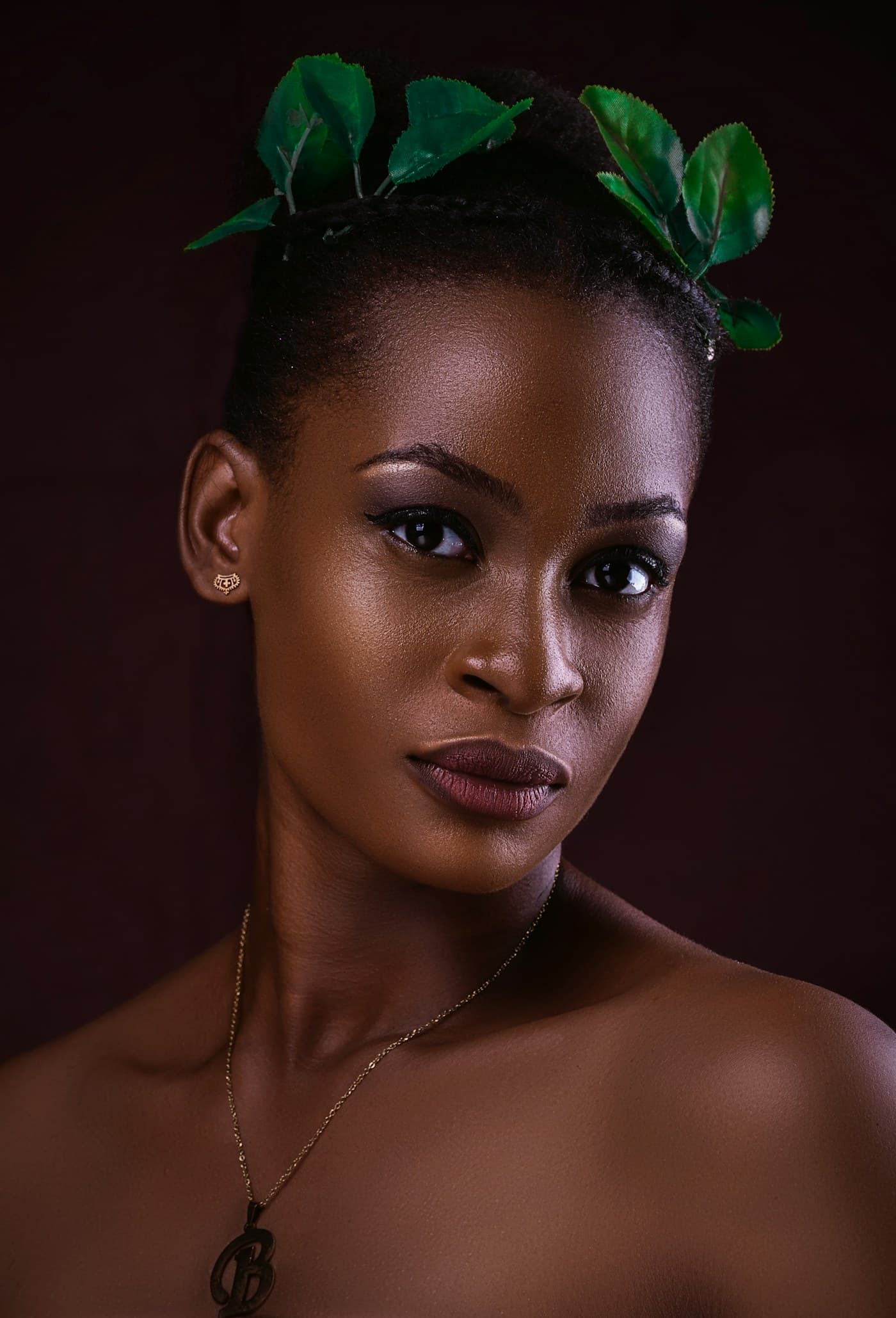 Woman with green leaves in her hair and soft makeup